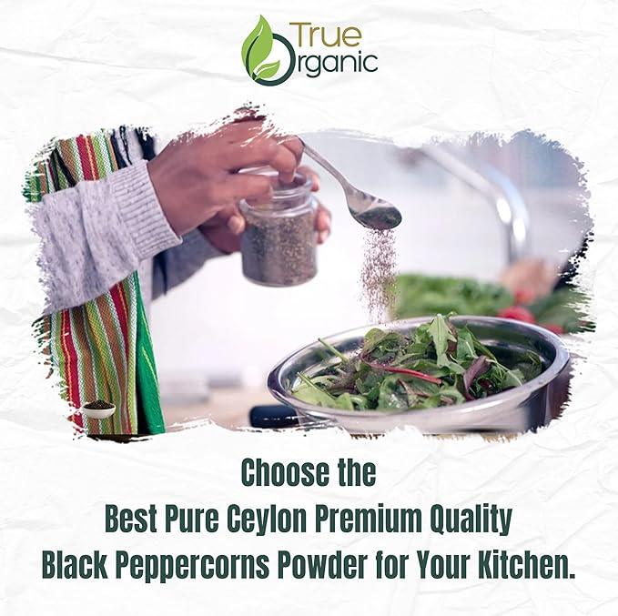 Person seasoning fresh mixed salad greens with True Organic Ceylon black peppercorn powder