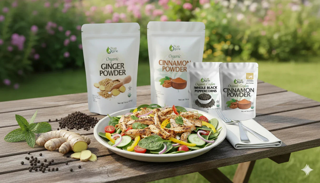 Organic ginger powder, cinnamon powder, and black peppercorns with fresh salad on wooden table outdoors